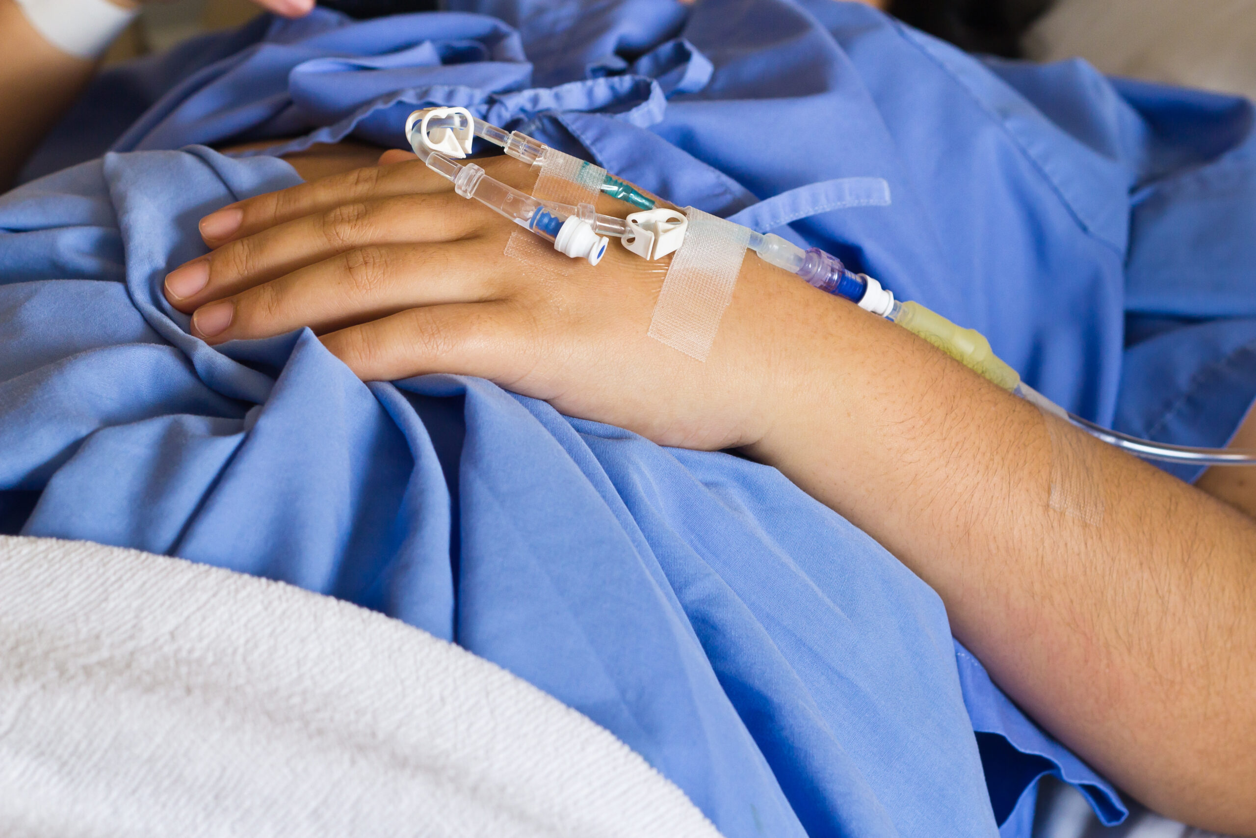 A hand patient with an intravenous drip Birth Education Center